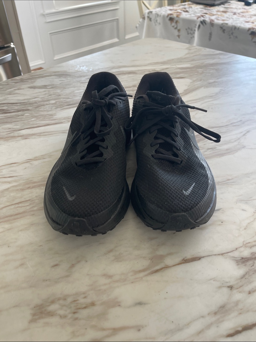 Nike Men's All-Black Breathable Athletic Sneakers. Woman worn